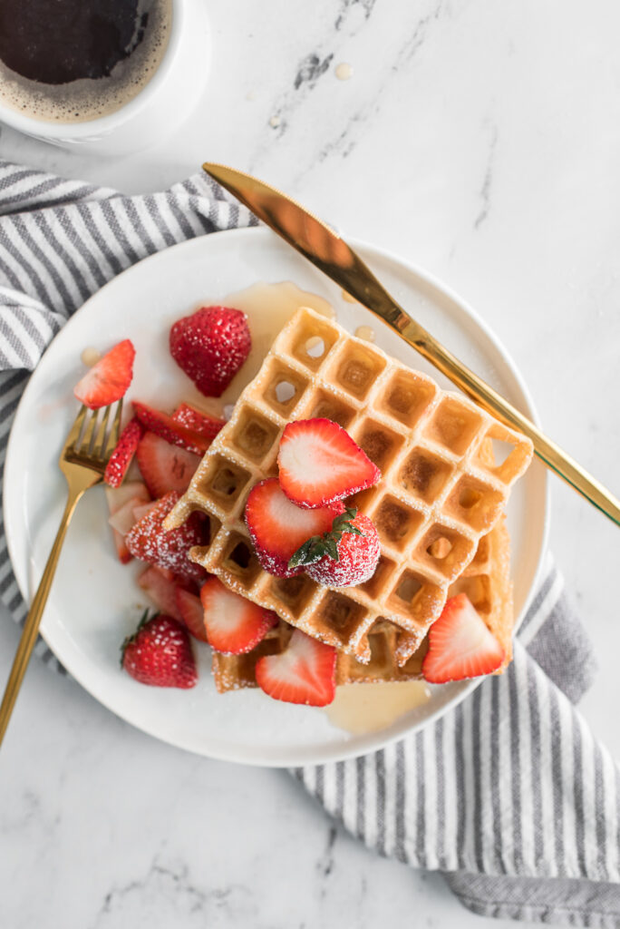Belgian waffles from an all clad waffle maker with strawberries, photographed by Connecticut-based food photographer Rebecca Hales