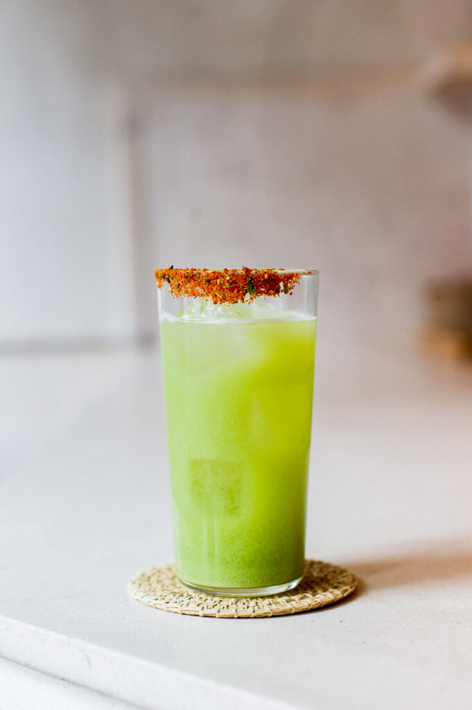 Cocktail with spicy garnish at a bar in NYC