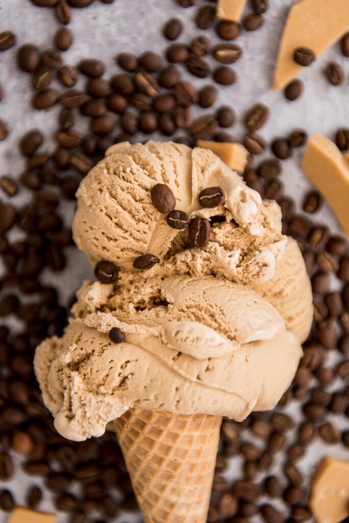Close-up of coffee ice cream with coffee beans, styled for Grassroots Ice Cream